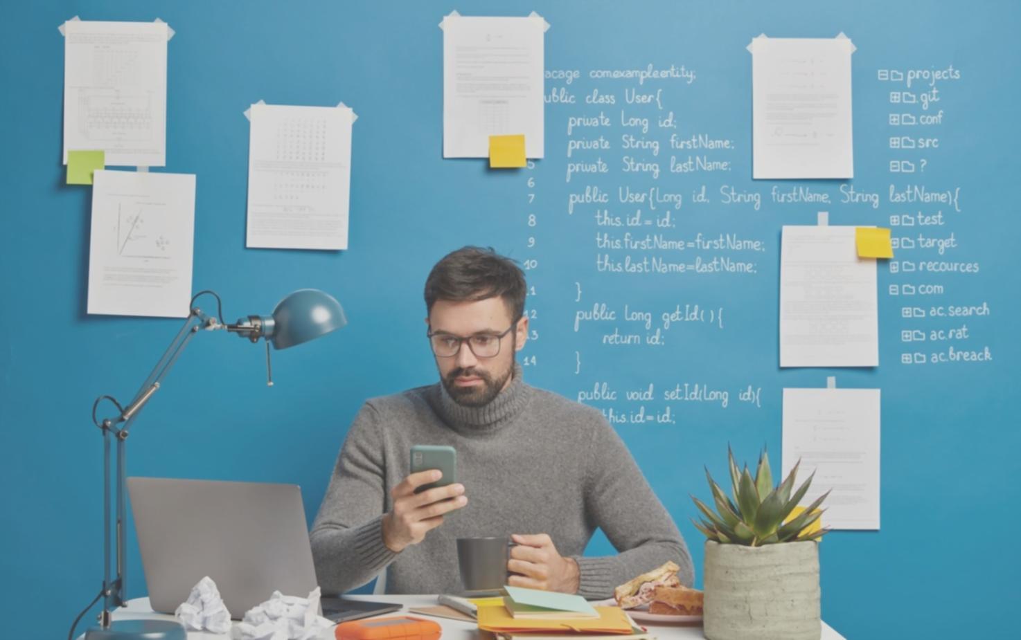 Custom software development workspace showing multiple monitors with code and system architecture diagrams